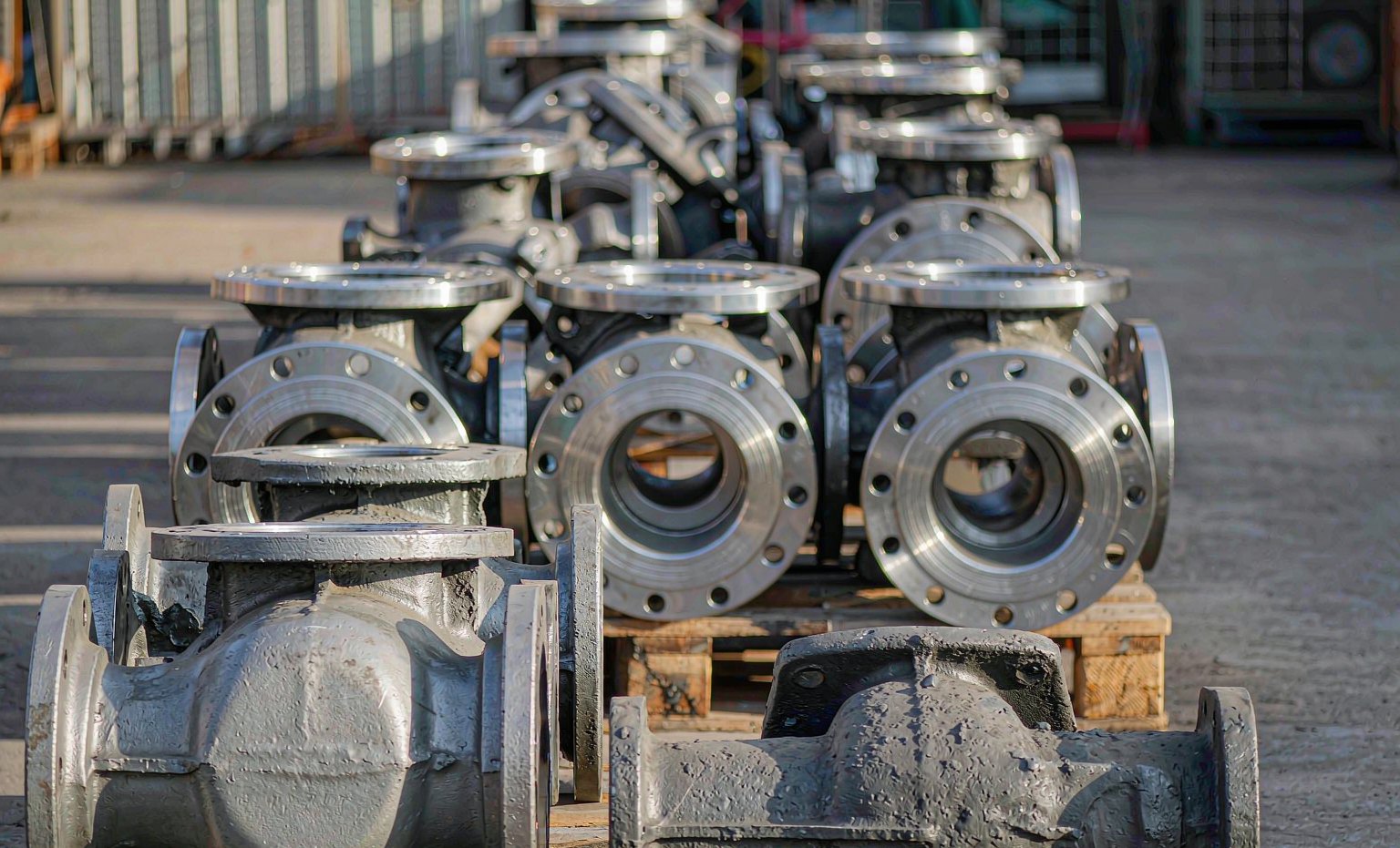 Rough and finish-machined valve body castings on a pallet